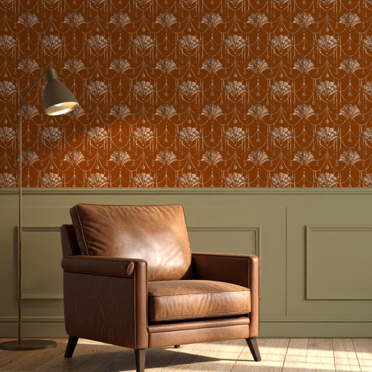 A styled interior scene showing a brown leather armchair in front of a wall with orange floral wallpaper and green wainscoting, plus a floor lamp and wood floor.