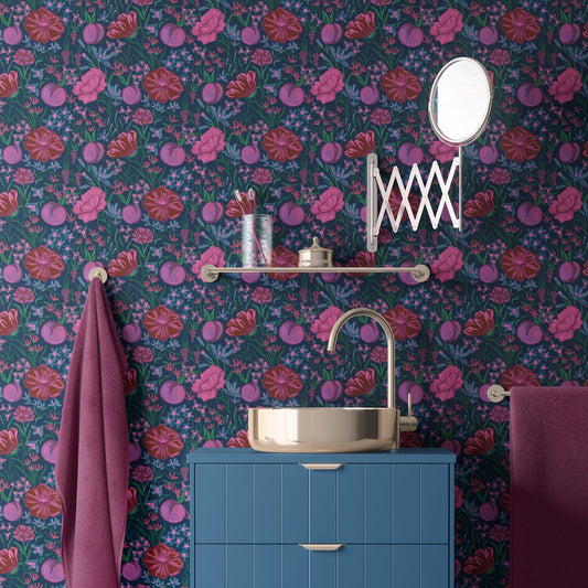 Navy and violet floral wallpaper in a bathroom with a blue vanity and brass basin