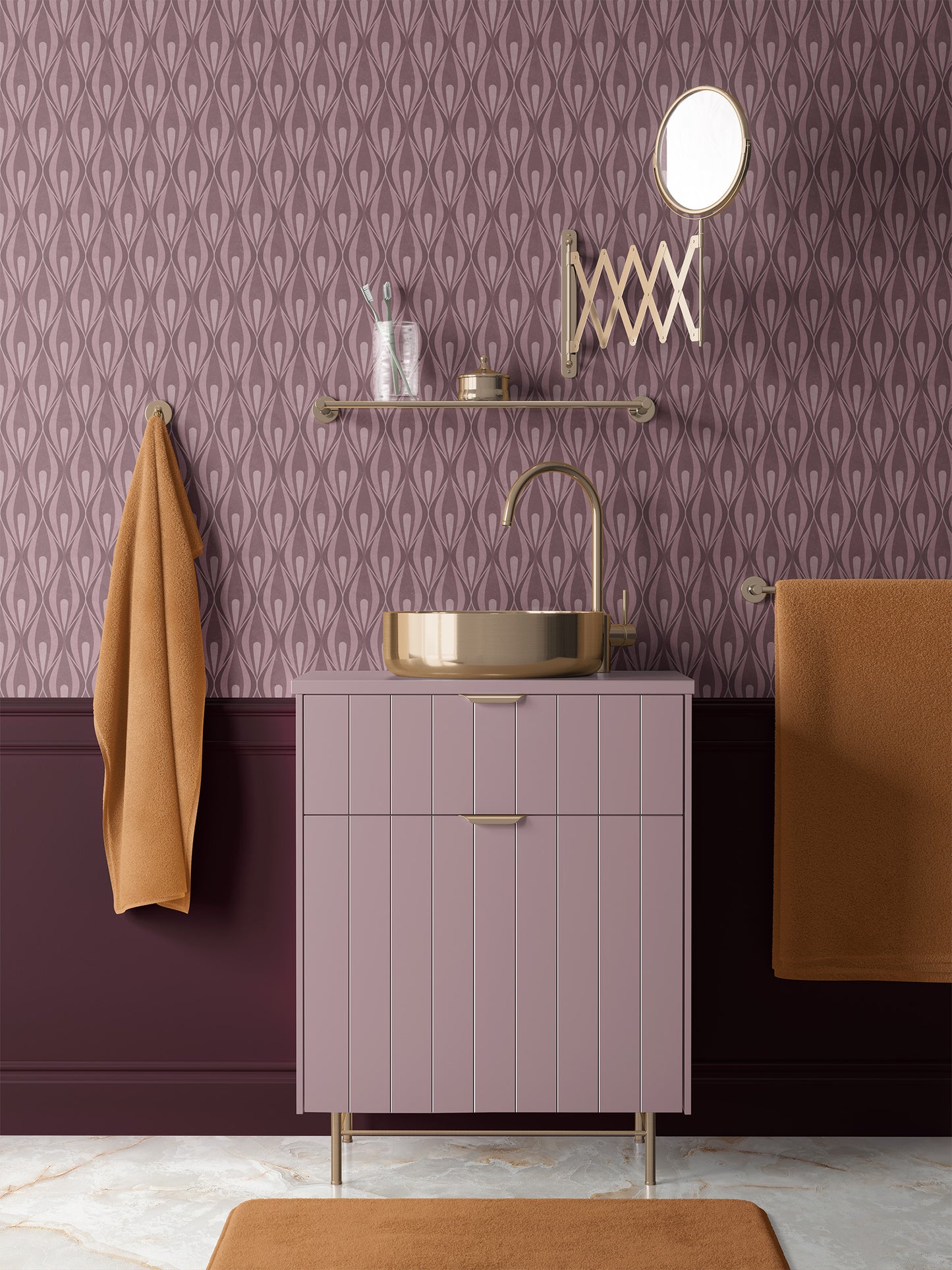 A modern bathroom vanity  with a dusty pink cabinet, gold faucet and mirror, 70s style dusty rose wallpaper, and warm brown towels hanging on the wall.