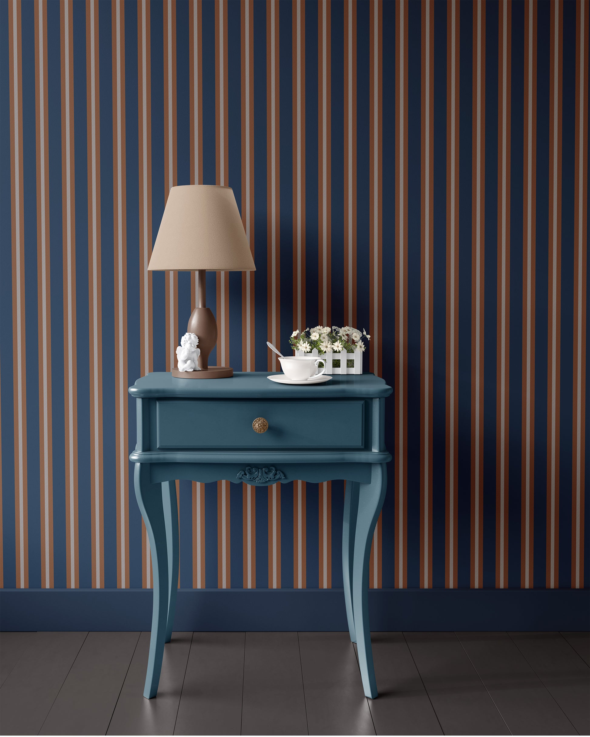 Blue side table with lamp and decorative items against a striped wall.