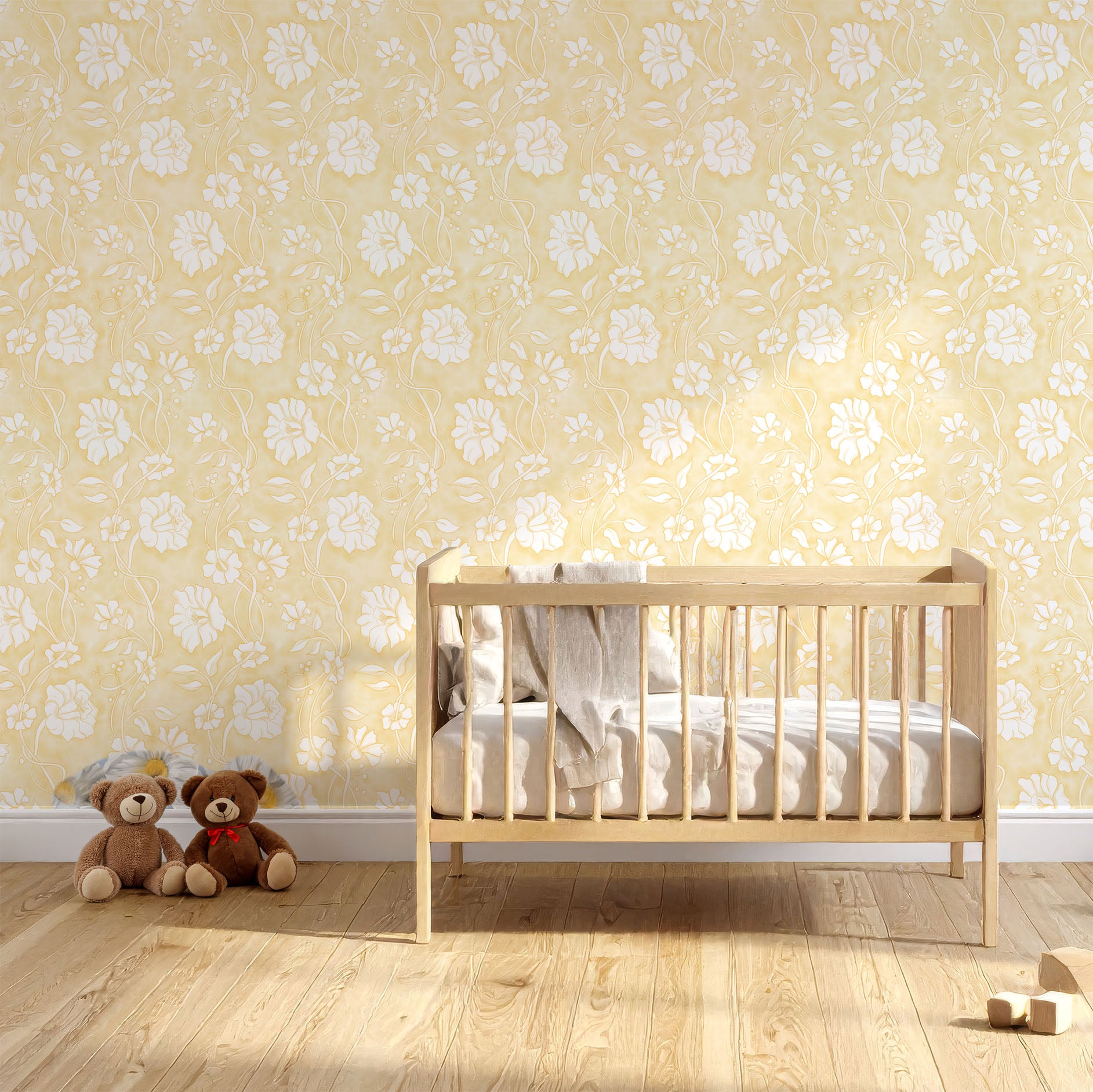 A nursery room scene with a light wood crib against a butter yellow floral wallpaper wall, with two teddy bears on the floor and a small pair of shoes nearby.