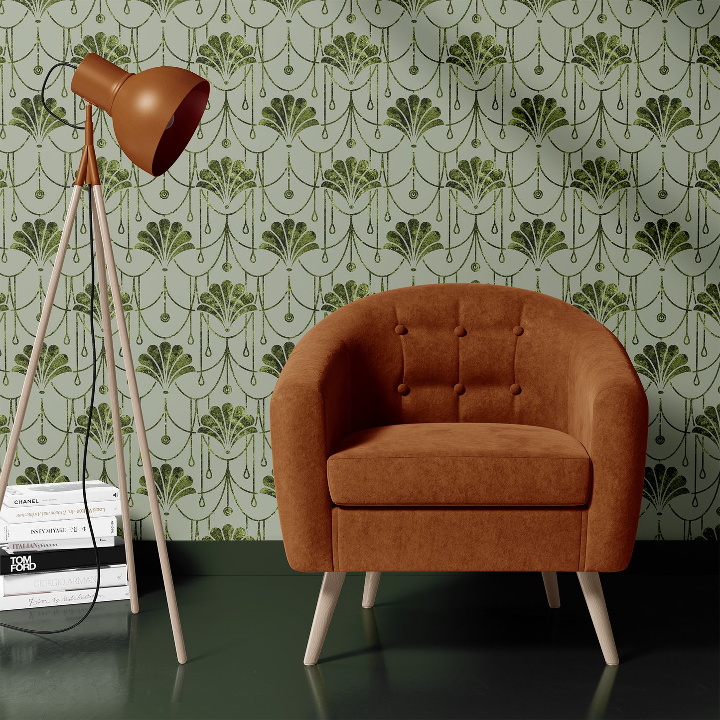 A mid-century modern accent chair upholstered in rust-brown velvet with light wood legs, set against a green and white Art Deco patterned wallpaper. A matching rust-brown tripod floor lamp stands to the left on a stack of books.