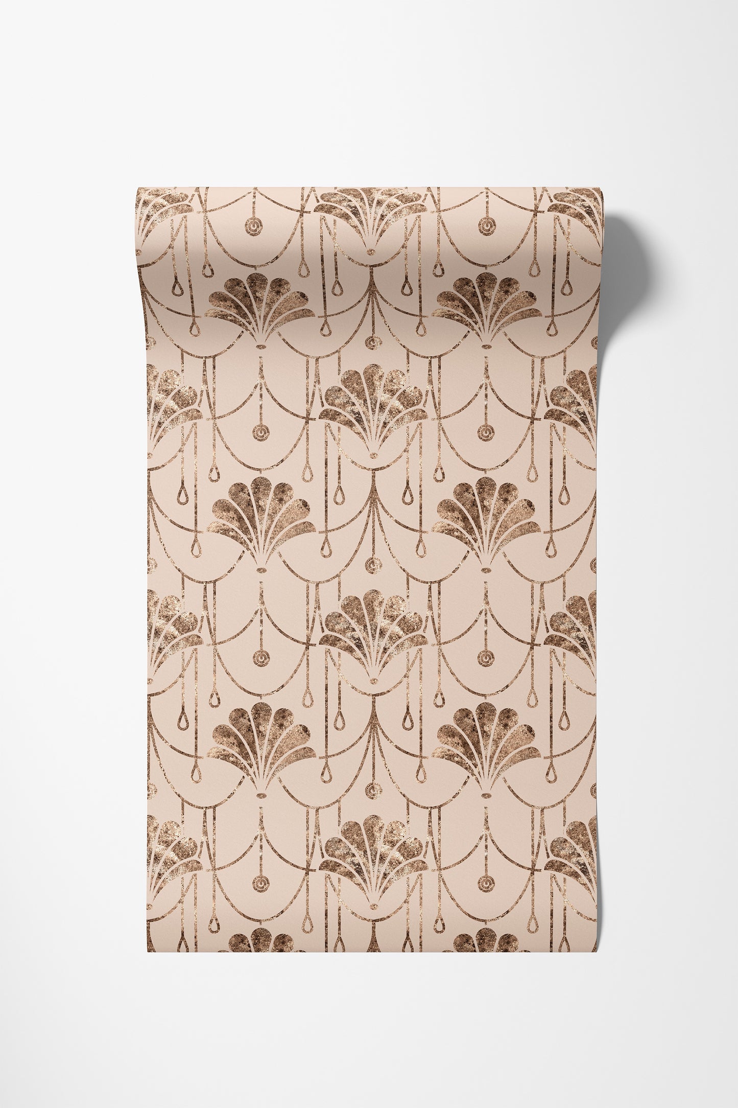 A roll of wallpaper with a repeating Art Deco fan and scallop pattern in a warm brown on a light beige background, shown against a plain white wall.
