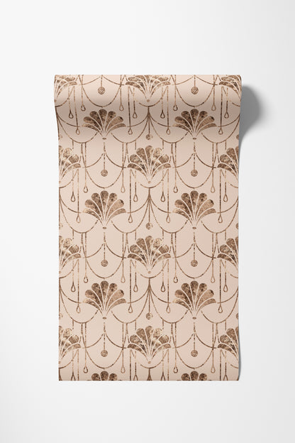 A roll of wallpaper with a repeating Art Deco fan and scallop pattern in a warm brown on a light beige background, shown against a plain white wall.