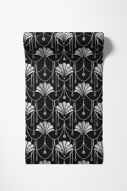 A rectangular black fabric item, likely a towel or blanket, featuring a repeating white Art Deco fan and chain pattern, shown against a plain white background.