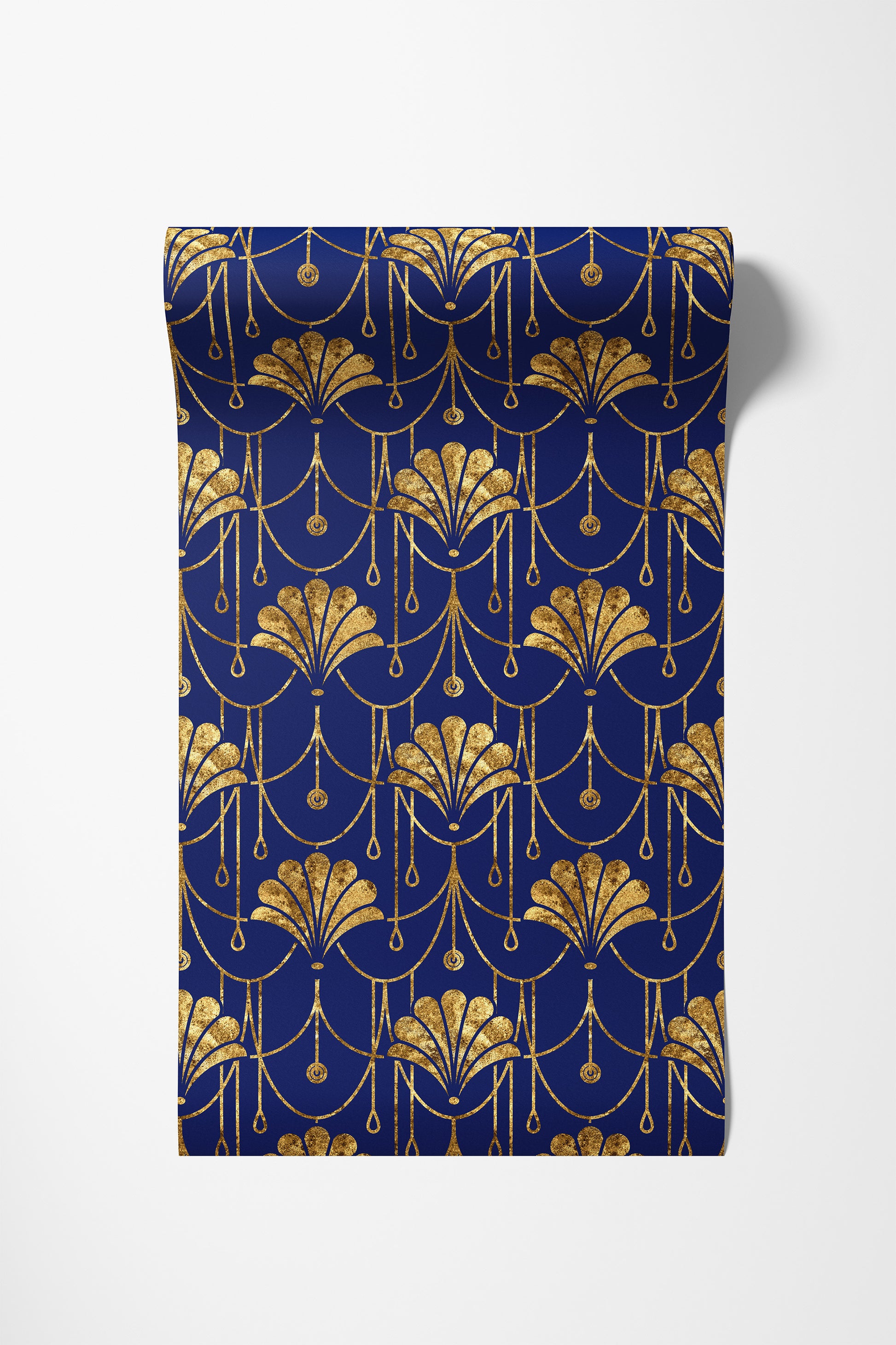 A rectangular fabric panel or napkin featuring an elegant Art Deco pattern in metallic gold on a deep navy blue background, displayed flat against a light gray studio backdrop.