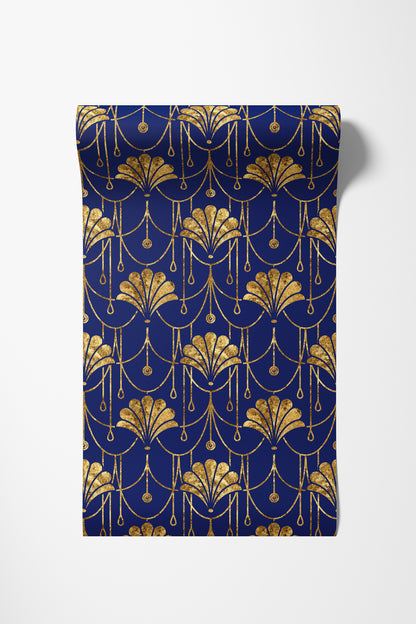 A rectangular fabric panel or napkin featuring an elegant Art Deco pattern in metallic gold on a deep navy blue background, displayed flat against a light gray studio backdrop.