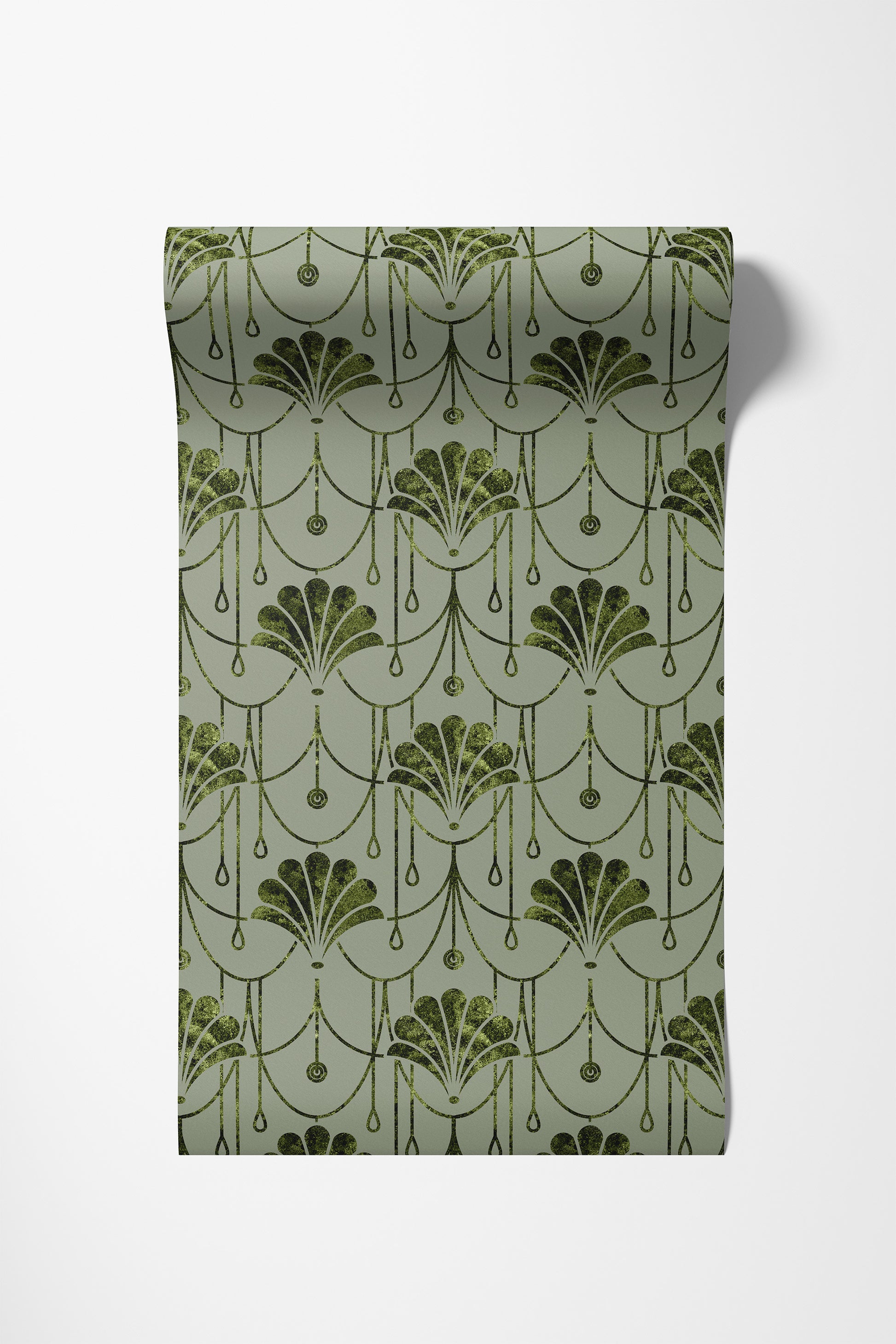 A roll of wallpaper with a repeating Art Deco fan pattern in dark olive green on a muted sage green background, shown against a plain white wall.