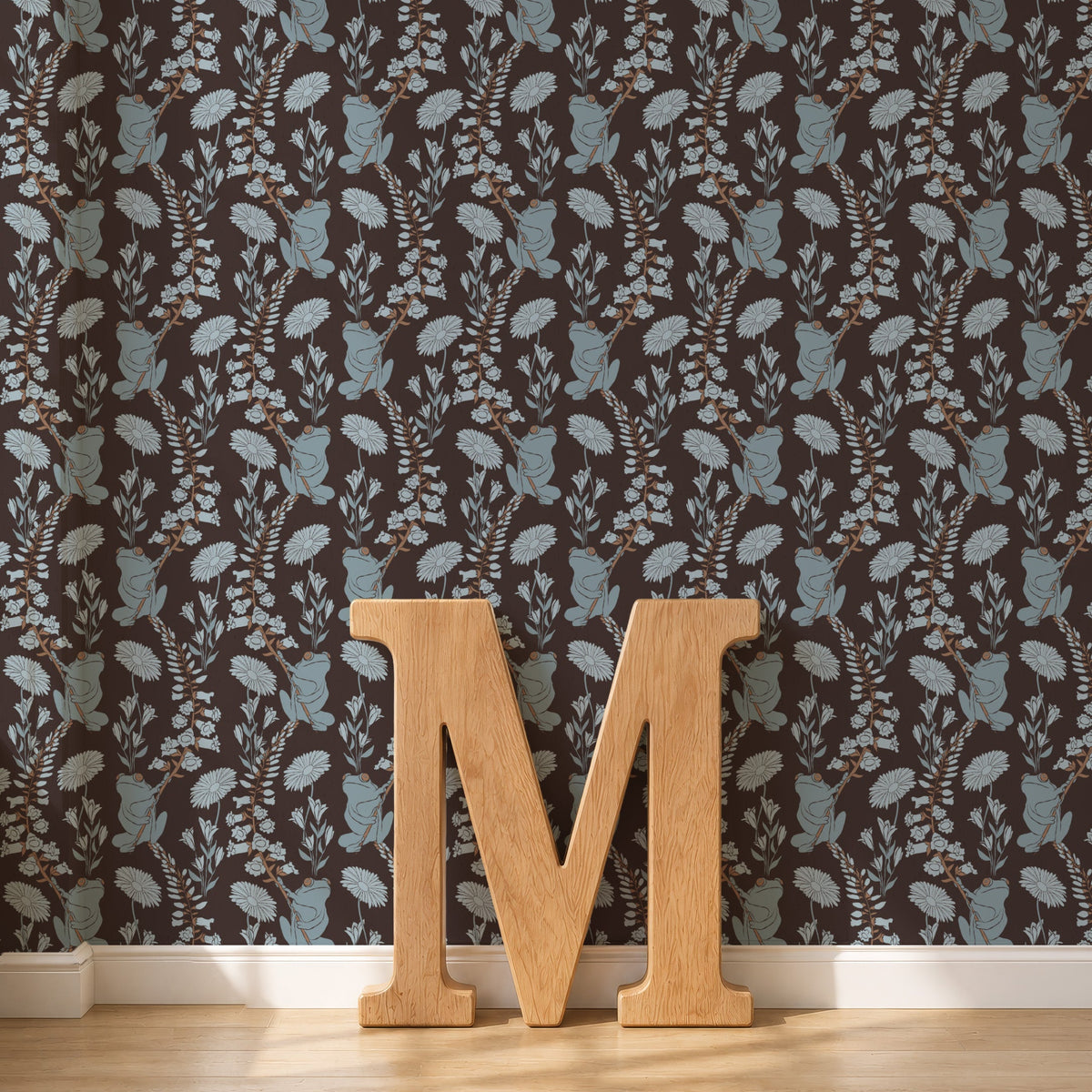 Dark brown frogs wallpaper behind a large wooden letter
