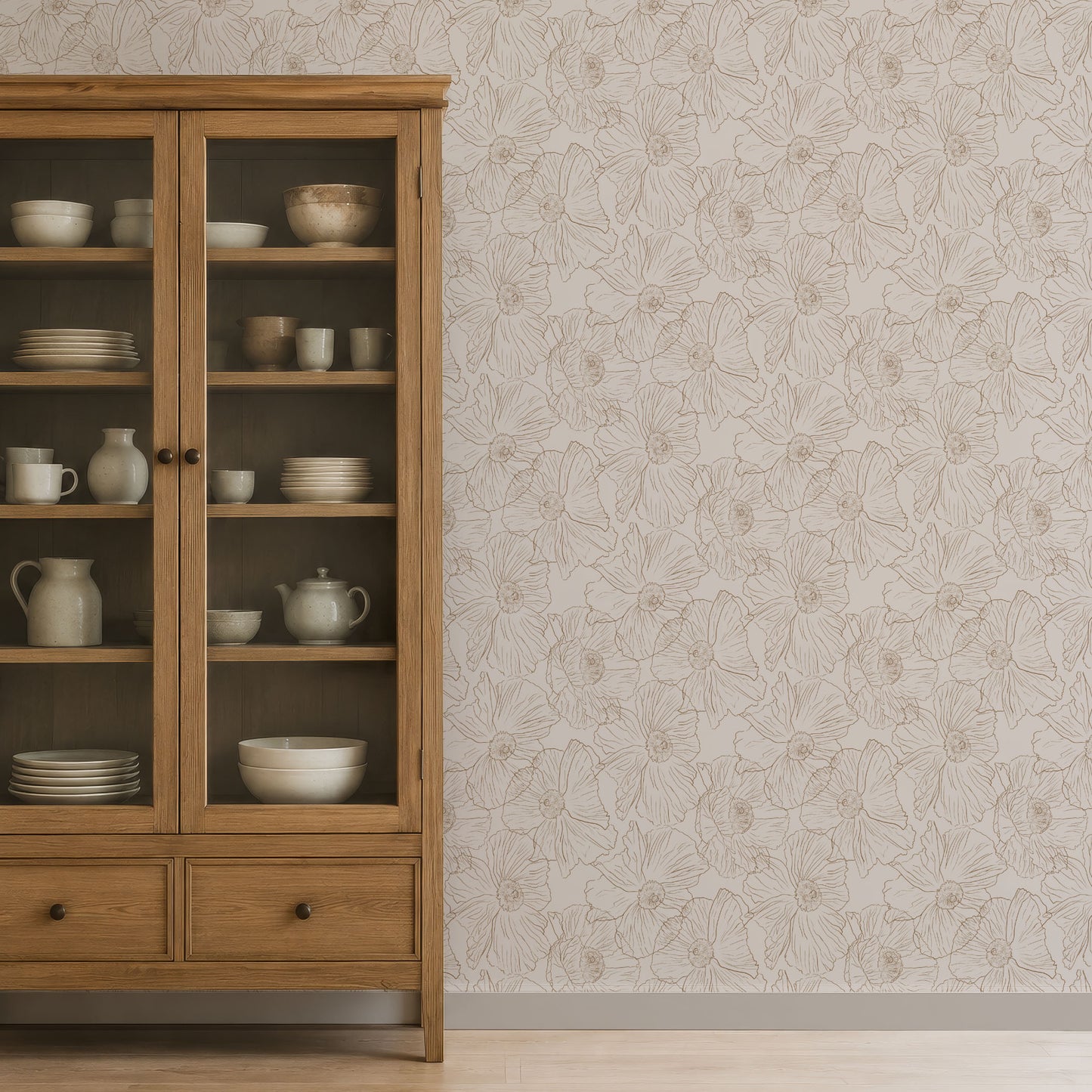 A tall wooden display cabinet filled with white ceramic dishes stands against a light beige wall with a subtle floral line pattern. The cabinet has two glass-front upper doors and two lower drawers with dark knobs.