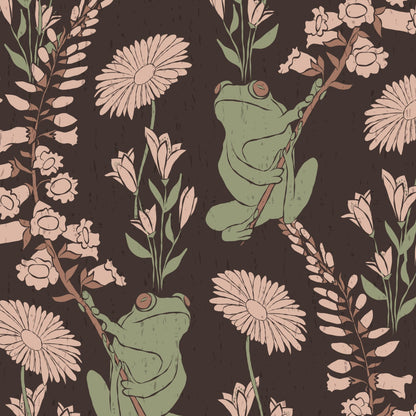 A repeating illustrated pattern featuring green frogs clinging to flowering branches against a dark brown background. The design includes pale flowers, muted green leaves, and brown stems in a vintage botanical style.
