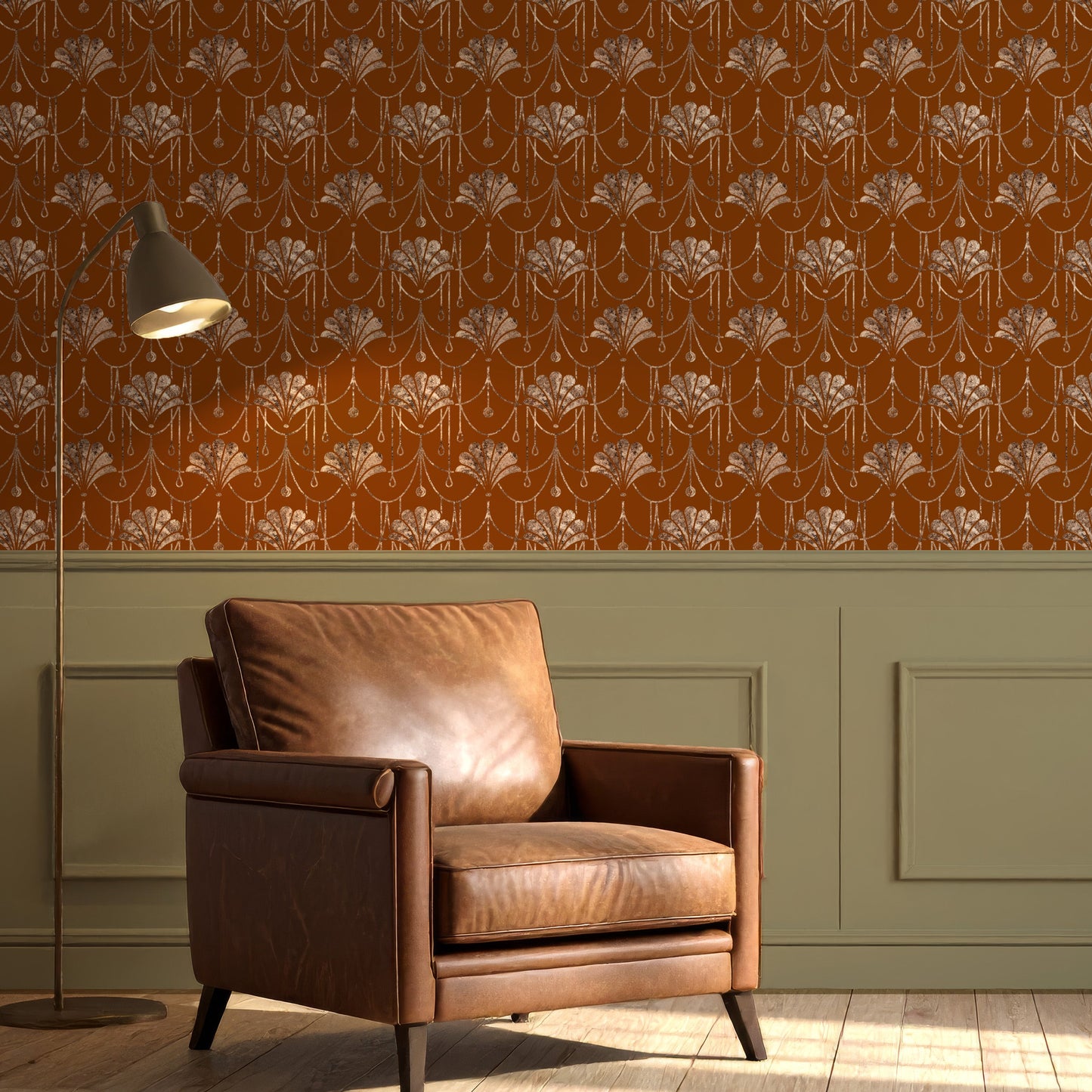 A styled interior scene showing a brown leather armchair in front of a wall with orange floral wallpaper and green wainscoting, plus a floor lamp and wood floor.