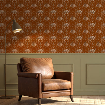 A styled interior scene showing a brown leather armchair in front of a wall with orange floral wallpaper and green wainscoting, plus a floor lamp and wood floor.
