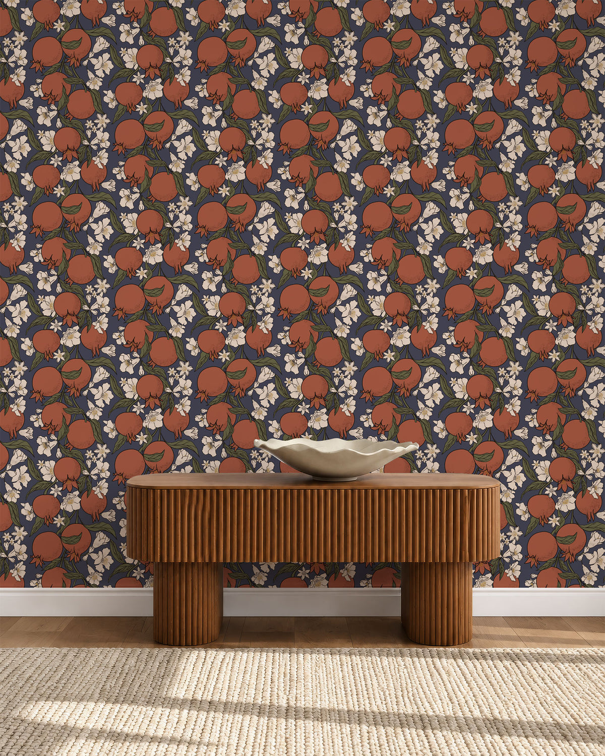 Rust pomegranate wallpaper on chocolate brown behind a ribbed wooden bench