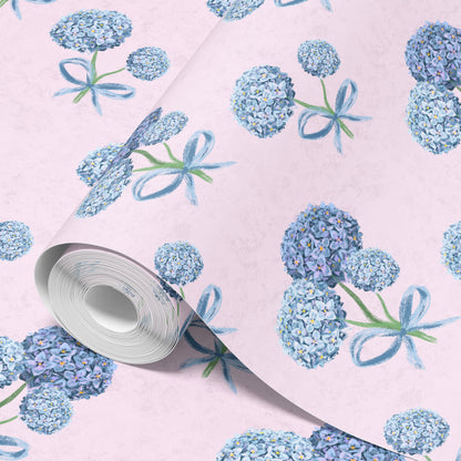 Roll of hydrangea wallpaper in blue on blush pink