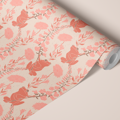 A roll of wallpaper with orange frogs, pink flowers