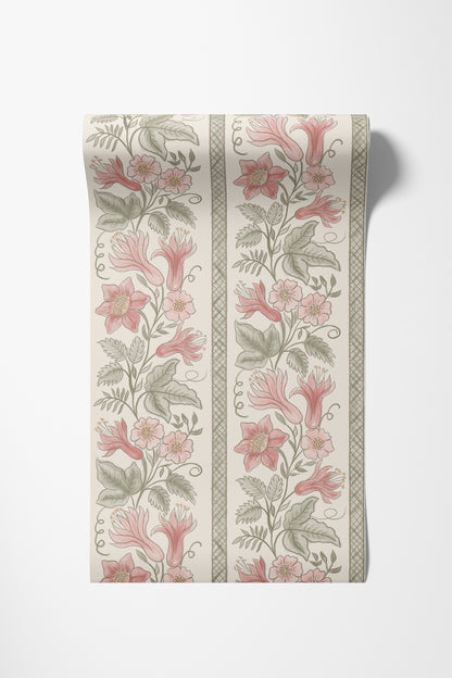 A roll of wallpaper with a girly vintage botanical pattern featuring pink flowers and green leaves on an off-white background, shown against a light gray wall.