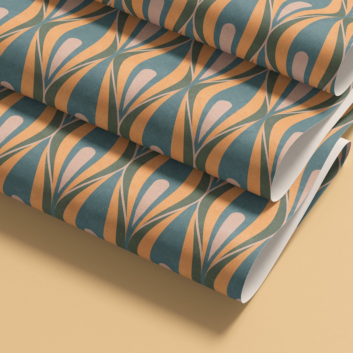 Rolled patterned wallpaper shown on a warm beige background. The wallpaper has a repeating mid-century style ogee  motif in teal blue, butter yellow, and pale blush 