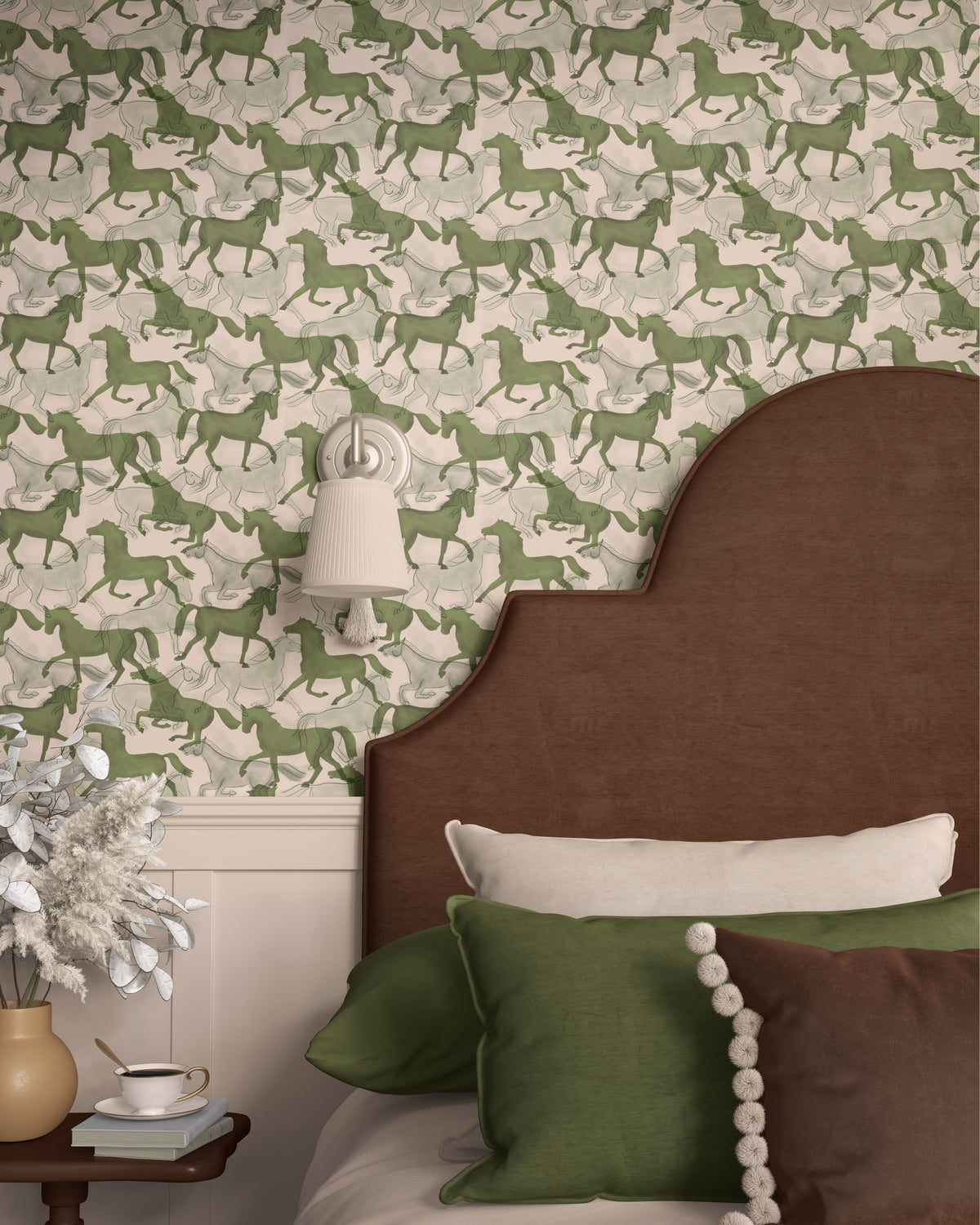 Sage green horses wallpaper behind an upholstered bed headboard