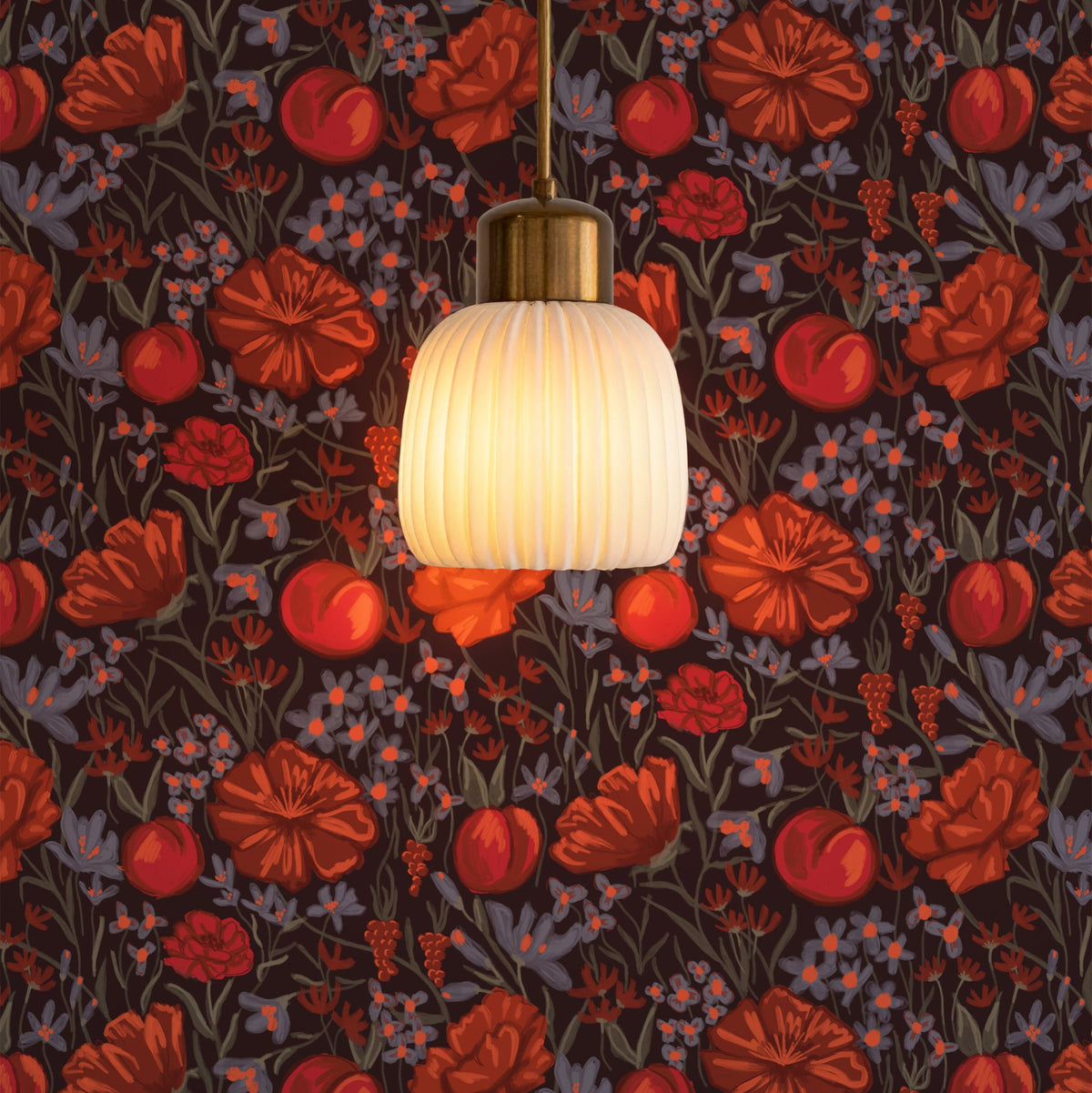 Red and orange floral wallpaper on dark brown behind a glass pendant lamp