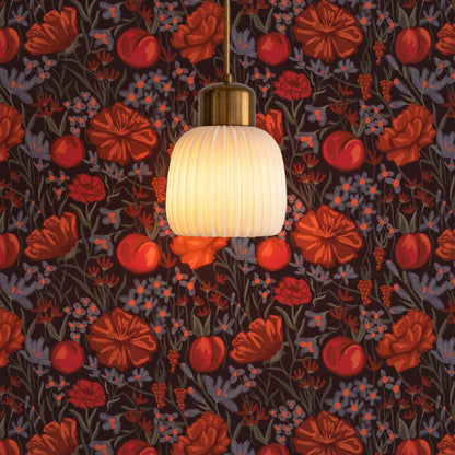 Red and orange floral wallpaper on dark brown behind a glass pendant lamp