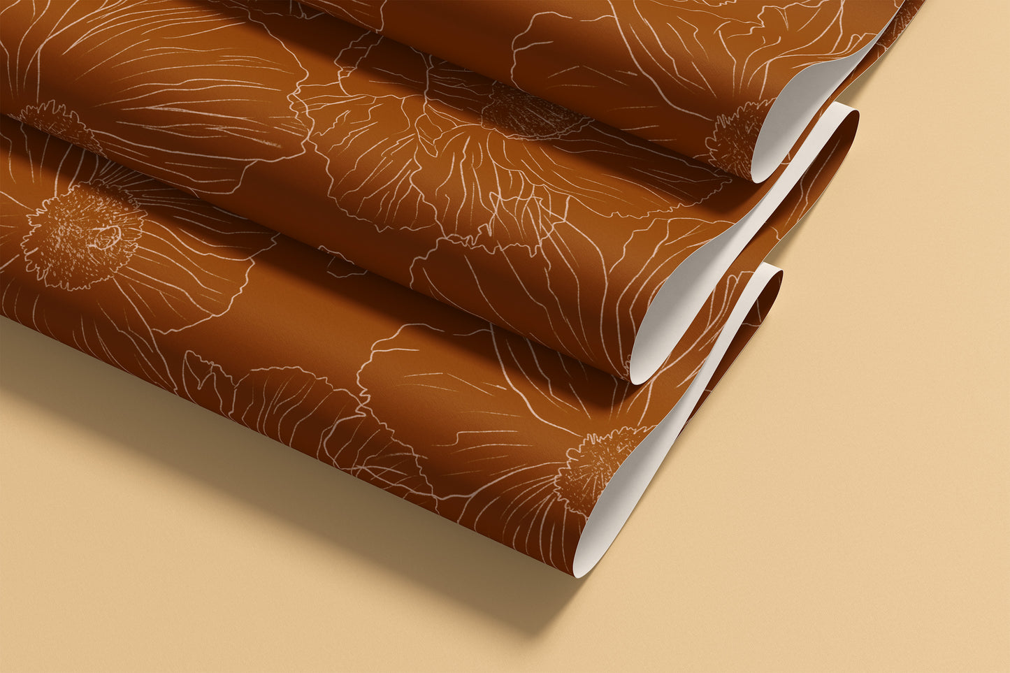 rolled sheets of terracotta patterned wallpaper with a light beige floral line design